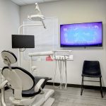 Dental operatory with patient chair and digital screen displaying teeth alignment at Kirkland Family Dentistry in Kirkland, WA
